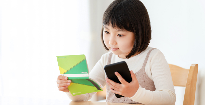 Female child with savings book and calculator