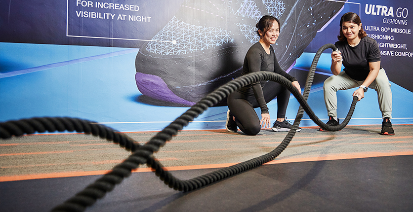 EnergyOne Personal Trainer Pei Lin with gym trainee using battle ropes