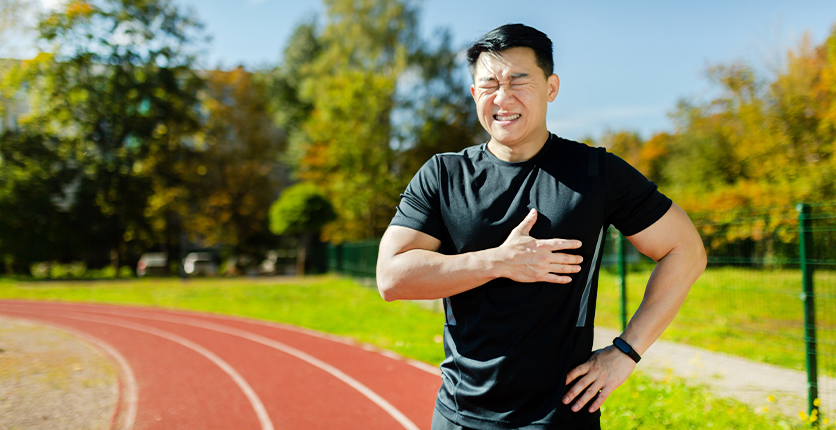 Man showing signs of heart strain after exercise