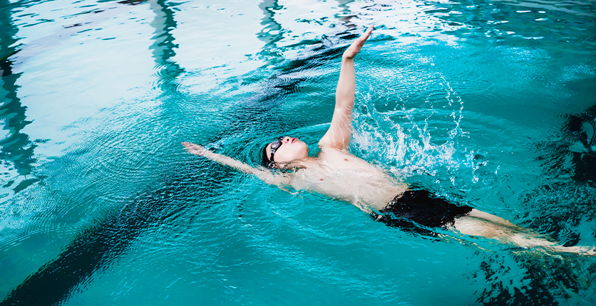 Man doing backstroke in pool