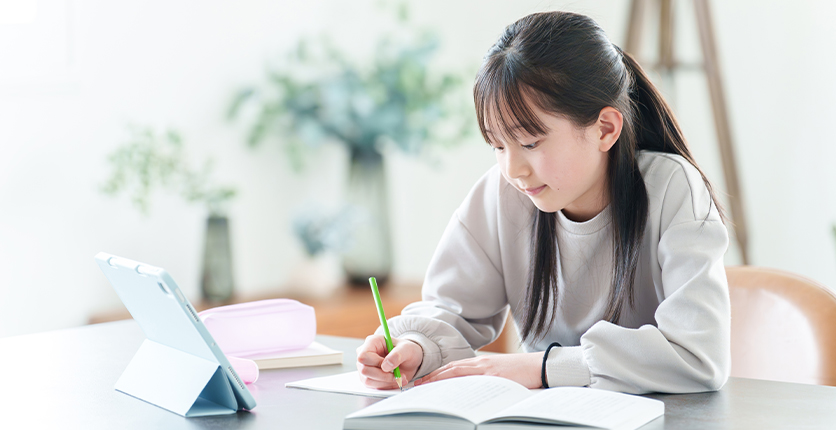 Young woman studying and writing