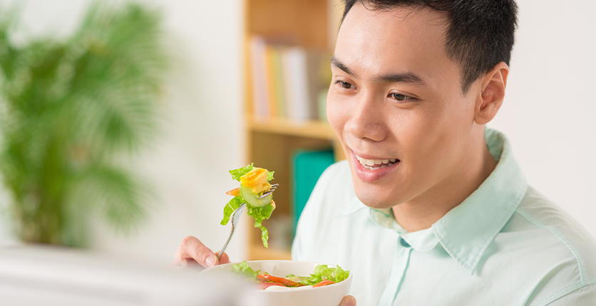 Young male enjoying a salad