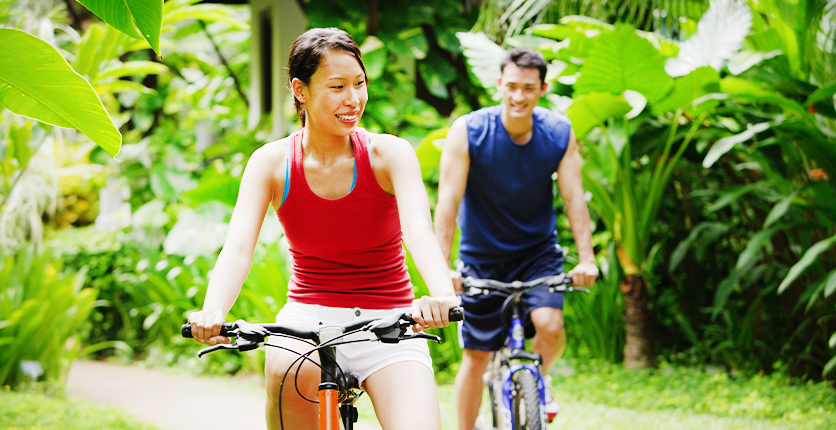 Young sporty couple on bicycles cycling