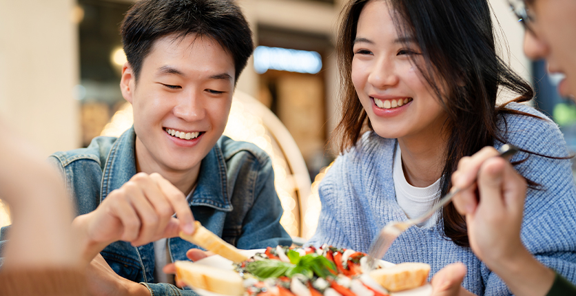 A young Asian couple sharing a meal